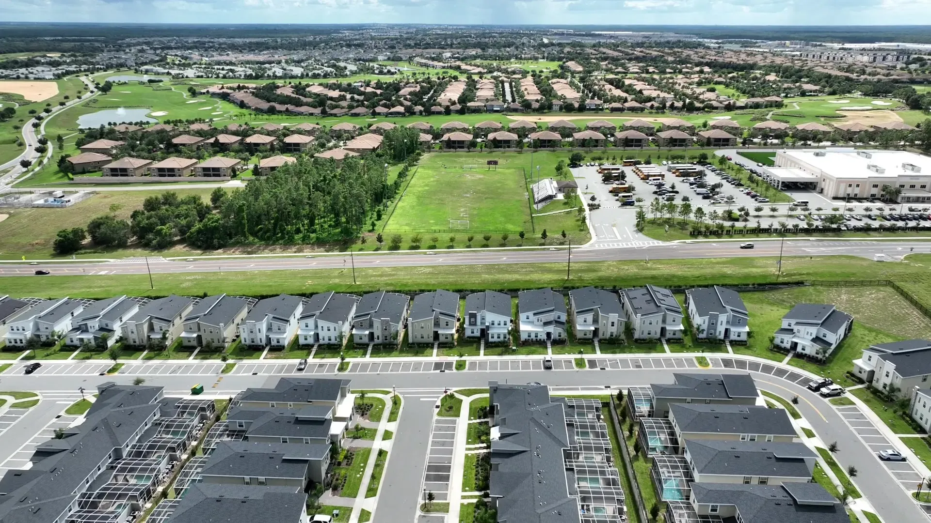 Aerial view of a modern suburban neighborhood with tree-lined streets and well-kept homes